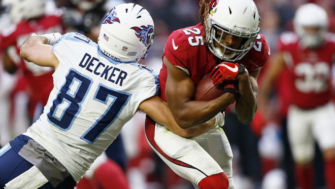Arizona Cardinals defensive back Tramon Williams (25) intercepts a pass intended for Tennessee Titans wide receiver Eric Decker (87) during a 2017 game.