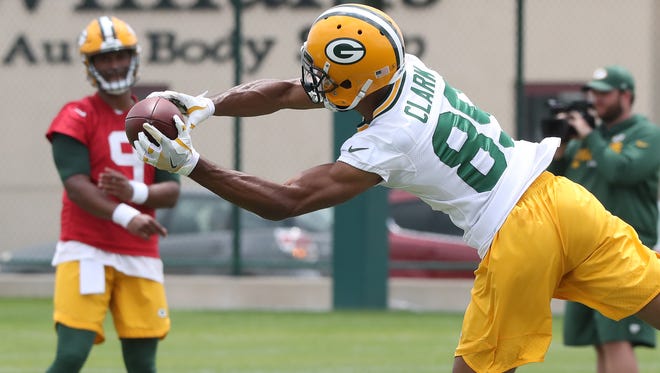Receiver Michael Clark (89) stretches for a pass from quarterback DeShone Kizer (9) during Green Bay Packers minicamp at Ray Nitschke Field Tuesday, June 12, 2018 in Ashwaubenon, Wis.