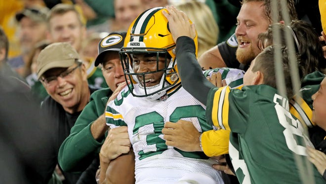 Green Bay Packers running back Aaron Jones (33) celebrates his touchdown with a Lambeau Leap on Sept. 28, 2017, against the Chicago Bears at Lambeau Field.