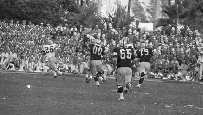 Green Bay Packers cornerback Herb Adderley (26) heads upfield on a 60-yard interception return for a touchdown during the fourth quarter of Green Bays 33-14 victory over Oakland in Super Bowl II at the Orange Bowl in Miami on Jan. 14, 1968. Raiders linemen Jim Otto (00), Wayne Hawkins (65) and Harry Schuh (79) give chase.