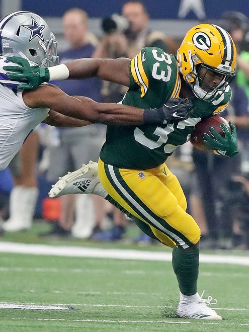 Green Bay Packers running back Aaron Jones (33) runs against the Dallas Cowboys on Oct. 8, 2017, at AT&T Stadium in Arlington, Texas.