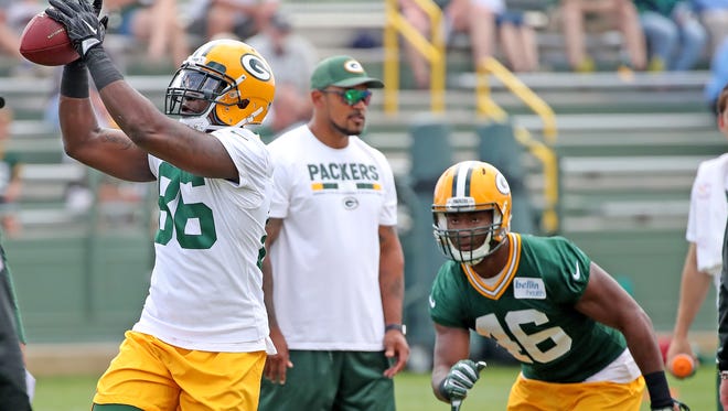 Green Bay Packers tight end Emanuel Byrd (86) catches a ball as linebacker Naashon Hughes moves in for the strip during Green Bay Packers minicamp at Ray Nitschke Field Tuesday, June 12, 2018 in Ashwaubenon, Wis.
