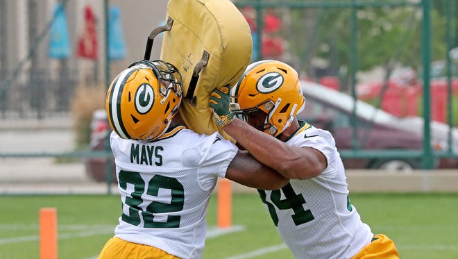 Running backs Devante Mays (32) and Joel Bouagnon (34) battle during a blocking drill at Green Bay Packers minicamp at Ray Nitschke Field Tuesday, June 12, 2018 in Ashwaubenon, Wis.