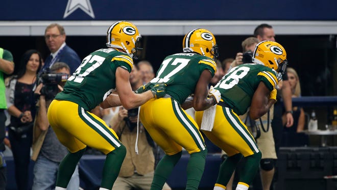Jordy Nelson, Davante Adams and Randall Cobb celebrate a touchdown with a bobsled demonstration.