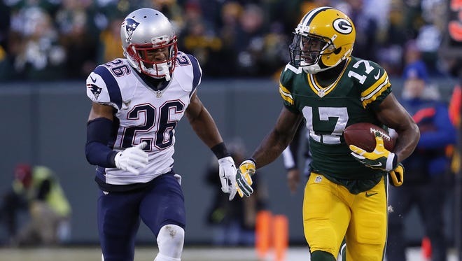 Green Bay Packers wide receiver Davante Adams (17) runs after a catch while being chased down by New England Patriots cornerback Logan Ryan (26).