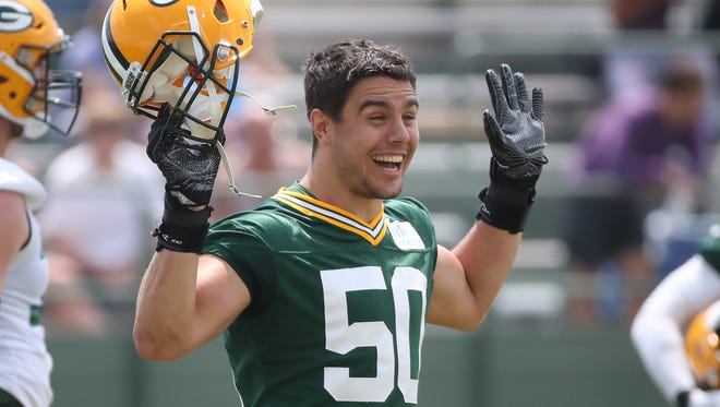 Green Bay Packers inside linebacker Blake Martinez (50) jokes with a buddy during Green Bay Packers minicamp at Ray Nitschke Field Tuesday, June 12, 2018 in Ashwaubenon, Wis.