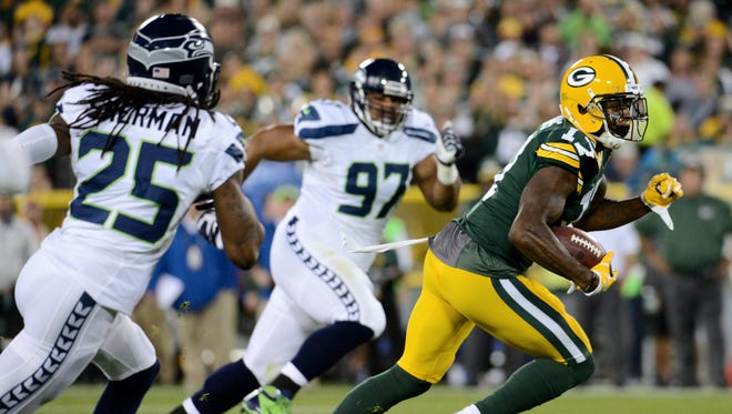 Green Bay Packers wide receiver Davante Adams (17) finds room to run while pursued by Seattle Seahawks cornerback Richard Sherman (25) and defensive tackle Jordan Hill (97) in the first quarter.