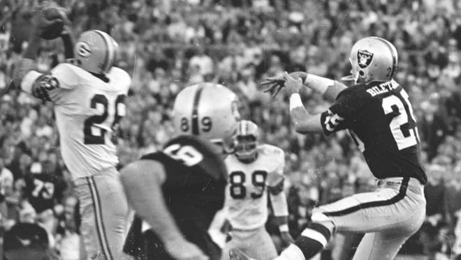 Green Bay Packers cornerback Herb Adderley (26), intercepts a pass intended for Raiders receiver Fred Biletnikoff (25) during the fourth quarter of Green Bays 33-14 victory over Oakland in Super Bowl II at the Orange Bowl in Miami on Jan. 14, 1968. Press-Gazette archives