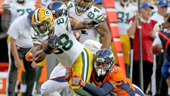 Green Bay Packers running back Ty Montgomery (88) runs the ball against the Denver Broncos on Aug. 26, 2017, at Sports Authority Field at Mile High in Denver.