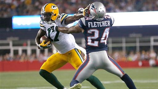 Green Bay Packers wide receiver Davante Adams  tries to escape the grasp of New England Patriots defensive back Bradley Fletcher (24) in the first half of a preseason football game on Thursday, Aug. 13, 2015, in Foxborough, Mass.
