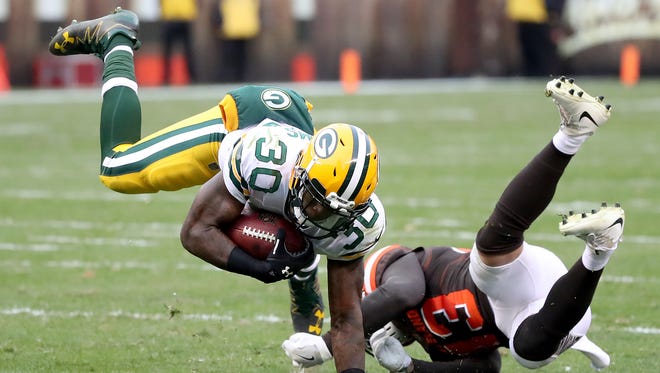 Green Bay Packers running back Jamaal Williams (30) gets upended on a run against the Cleveland Browns on Dec. 10, 2017, at FirstEnergy Stadium in Cleveland.