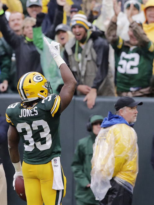 Green Bay Packers running back Aaron Jones (33) celebrates his touchdown in the first quarter against the New Orleans Saints on Oct. 22, 2017, at Lambeau Field.