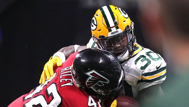 Green Bay Packers running back Jamaal Williams (30) picks up a first down in the fourth quarter with Atlanta Falcons outside linebacker Duke Riley (42) defending on Sept. 17, 2017, at Mercedes-Benz Stadium in Atlanta.