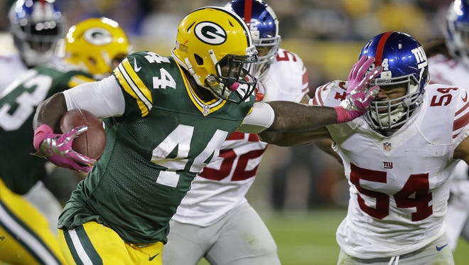 Packers running back James Starks stiff arms New York Giants outside linebacker J.T. Thomas in Green Bay's 23-16 win Oct. 9 at Lambeau Field.