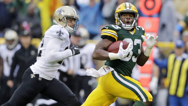 Green Bay Packers running back Aaron Jones (33) runs for a touchdown in the first quarter against the New Orleans Saints on Oct. 22, 2017, at Lambeau Field.