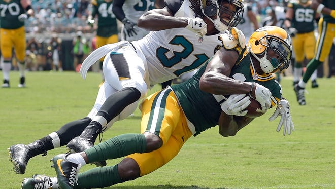 Green Bay Packers wide receiver Davante Adams (17) makes a touchdown catch in front of Jacksonville Jaguars cornerback Davon House (31) during the first half Sunday, Sept. 11, 2016.
