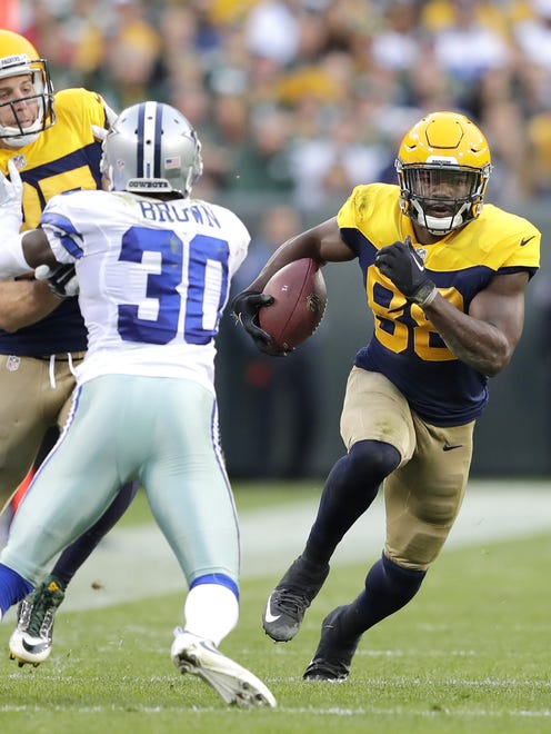 Green Bay Packers receiver Ty Montgomery runs as Jordy Nelson blocks Dallas Cowboys cornerback Anthony Brown following a reception in the second half of a 2016 game at Lambeau Field.