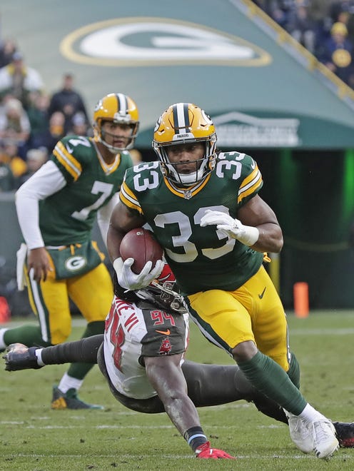 Green Bay Packers running back Aaron Jones (33) rushes for the game-winning touchdown in overtime against the Tampa Bay Buccaneers on Dec. 3, 2017, at Lambeau Field.