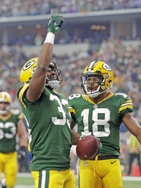 Green Bay Packers running back Aaron Jones and wide receiver Randall Cobb celebrate a touchdown against the Dallas Cowboys during a 2017 game at AT&T Stadium in Arlington, Texas.