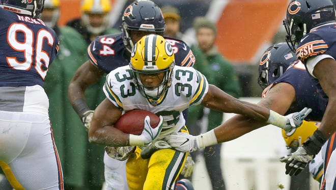 Green Bay Packers running back Aaron Jones (33) runs through defenders for a gain during the 1st quarter against the Chicago Bears at Soldier Field on Sunday, November 12, 2017.