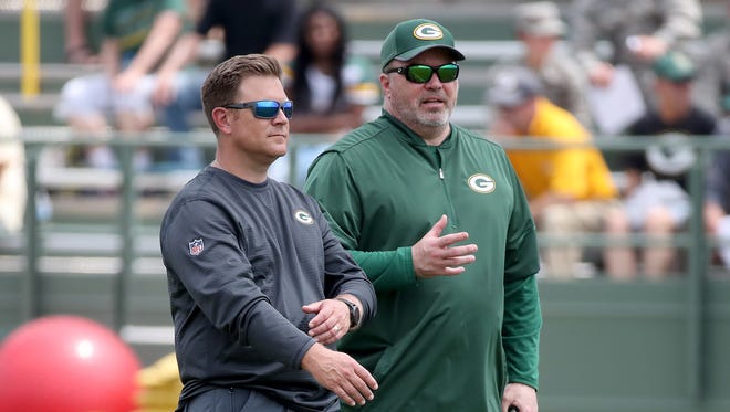 Packers head coach Mike McCarthy, right, talks with general manager Brian Gutekunst during Green Bay Packers minicamp at Ray Nitschke Field Tuesday, June 12, 2018 in Ashwaubenon, Wis.