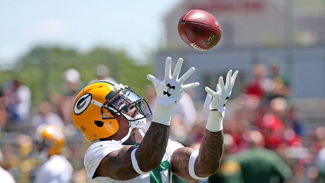 Green Bay Packers running back Jamaal Williams (30) catches a pass during minicamp on June 13, 2018, at Ray Nitschke Field.