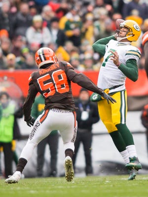 Green Bay Packers quarterback Brett Hundley (7) throws a pass for a touchdown under pressure from Cleveland Browns outside linebacker Christian Kirksey (58) during the first quarter at FirstEnergy Stadium.