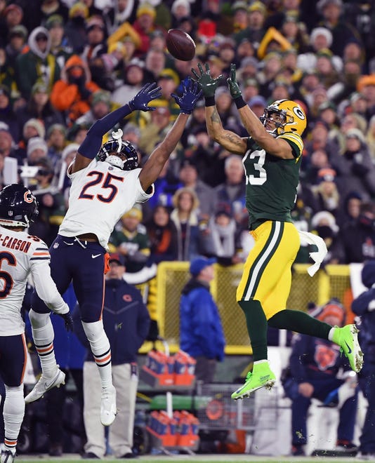 Allen Lazard (13) of the Green Bay Packers makes a 32-yard reception over Artie Burns (25) of the Chicago Bears during the first quarter at Lambeau Field on December 12, 2021 in Green Bay, Wis.