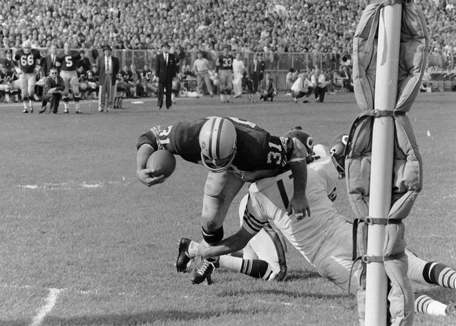 Green Bay Packers fullback Jim Taylor (31) scores a touchdown against Richie Petitbon (17). The Packers defeated the Chicago Bears 49-0 on Sept. 30, 1962, at New City Stadium, later renamed Lambeau Field, in Green Bay, Wis.