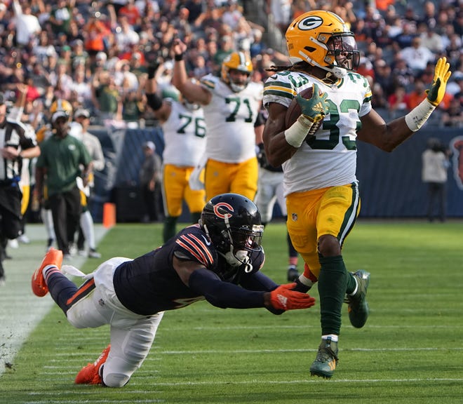 Green Bay Packers running back Aaron Jones (33) picks up 51 yards on reception while Chicago Bears safety Eddie Jackson (4) misses a tackle during the third quarter of their regular season opening game Sunday, September 10, 2023 at Soldier Field in Chicago, Ill. The Green Bay Packers beat the Chicago Bears 38-20.