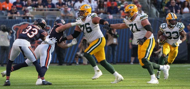 Green Bay Packers guard Jon Runyan (76) and center Josh Myers (71) clears a path for running back Aaron Jones (33) during the third quarter of their regular season opening game Sunday, September 10, 2023 at Soldier Field in Chicago, Ill. The Green Bay Packers beat the Chicago Bears 38-20.