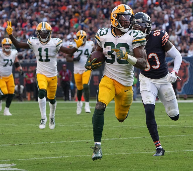 Green Bay Packers running back Aaron Jones (33) scores a touchdown on a 35-yard reception during the third quarter of their regular season opening game Sunday, September 10, 2023 at Soldier Field in Chicago, Ill. The Green Bay Packers beat the Chicago Bears 38-20.