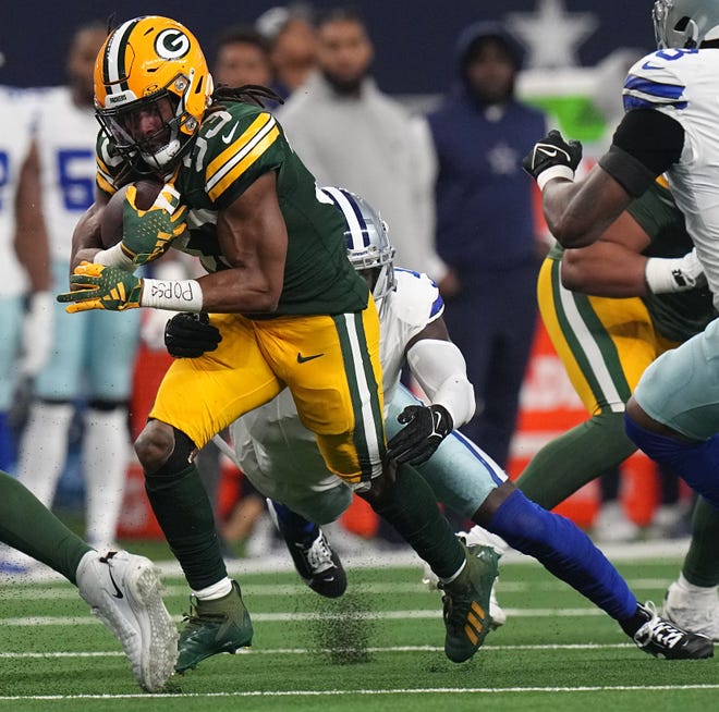 Green Bay Packers running back Aaron Jones (33) finds a hole in the Dallas Cowboys defense during the first quarter of the wild card playoff game Sunday, January 14, 2024 at AT&T Stadium in Arlington, Texas.