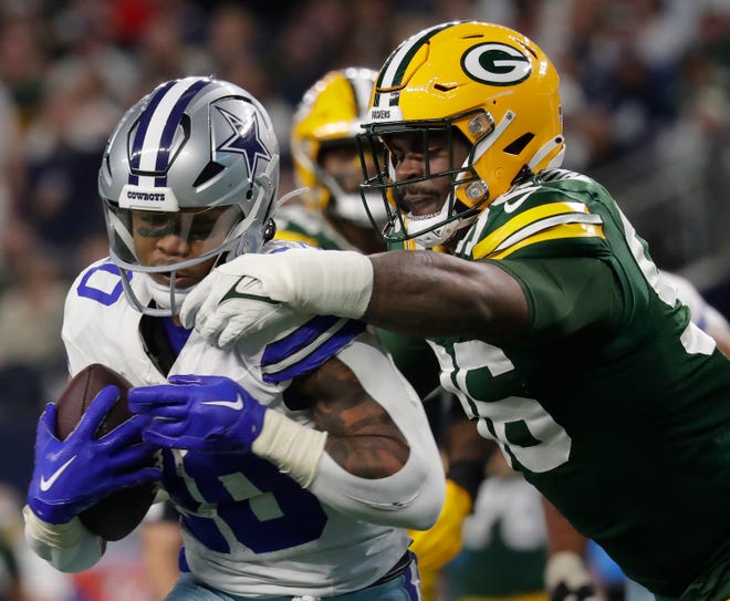 Green Bay Packers defensive tackle Colby Wooden (96) tackles Dallas Cowboys running back Tony Pollard (20) during the third quarter of their wild card playoff game Sunday, January 14, 2024 at AT&T Stadium in Arlington, Texas. Green Bay defeated Dallas 48-32.