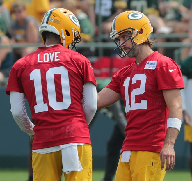 Green Bay Packers quarterback Aaron Rodgers (12) talks with quarterback Jordan Love (10) during the first day of training camp on July 28, 2021 in Green Bay, Wis.