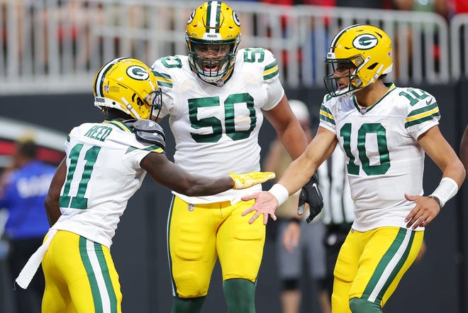 Jayden Reed (11) of the Green Bay Packers celebrates a touchdown with Jordan Love (10) during the second quarter in the game against the Atlanta Falcons at Mercedes-Benz Stadium on Sept. 17, 2023 in Atlanta, Georgia.