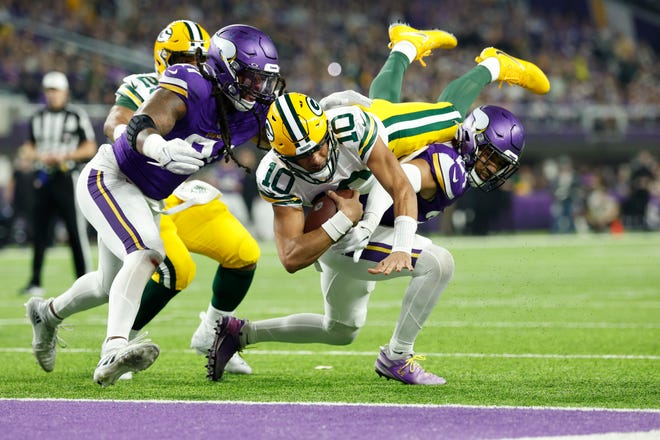 Jordan Love (10) of the Green Bay Packers dives for a touchdown during the second quarter against the Minnesota Vikings at U.S. Bank Stadium on Dec. 31, 2023 in Minneapolis, Minnesota.