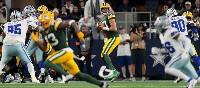Green Bay Packers quarterback Jordan Love (10) looks for a receiver during the first quarter of the wild card playoff game on Jan. 14, 2024 at AT&T Stadium in Arlington, Texas. The Green Bay Packers beat the Dallas Cowboys 48-32.