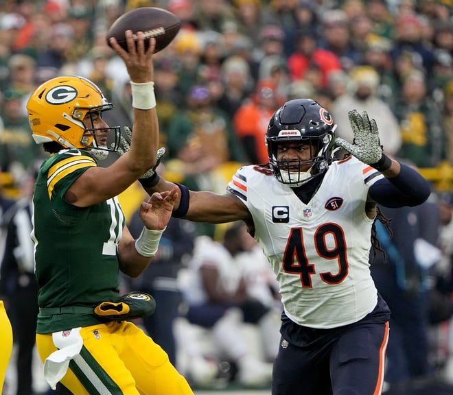 Green Bay Packers quarterback Jordan Love (10) is pressured by Chicago Bears linebacker Tremaine Edmunds (49) during the first quarter of their game Sunday, January 7, 2024 at Lambeau Field in Green Bay, Wisconsin.