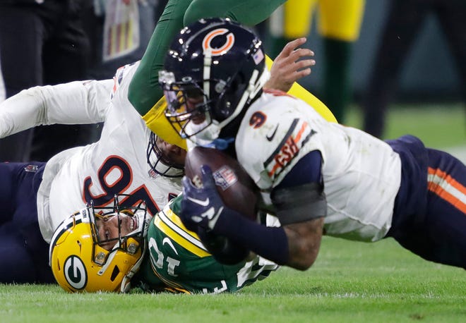 Green Bay Packers quarterback Jordan Love (10) looks on as Chicago Bears safety Jaquan Brisker (9) recovers his fumble in the third quarter during their football game Sunday, January 7, 2024, in Green Bay, Wisconsin.