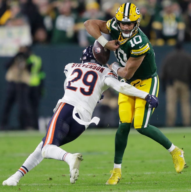 Chicago Bears cornerback Tyrique Stevenson forces a fumble by Green Bay Packers quarterback Jordan Love (10) in the third quarter during their football game Sunday, January 7, 2024, in Green Bay, Wisconsin.