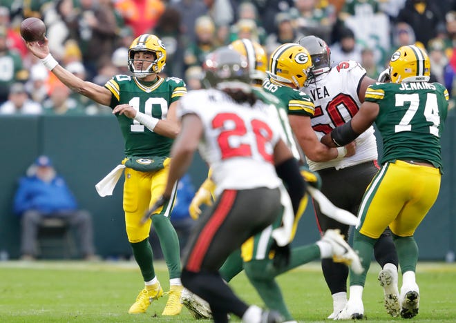 Green Bay Packers quarterback Jordan Love (10) passes the ball to wide receiver Jayden Reed (11) against the Tampa Bay Buccaneers during their football game Sunday, December 17, 2023, at Lambeau Field in Green Bay, Wis.