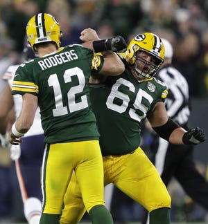 Green Bay Packers quarterback Aaron Rodgers (12) celebrates with Lane Taylor (65) after throwing a touchdown pass to Geronimo Allison (81) in the fourth quarter Sunday, Sept. 9, 2018, at Lambeau Field in Green Bay, Wis.