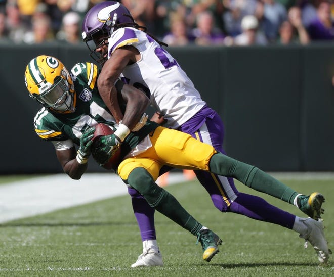 Green Bay Packers' Geronimo Allison catches a pass in front 0f Minnesota Vikings' Trae Waynes during their football game on Sunday, September 16, 2018, at Lambeau Field in Green Bay, Wis. The game ended in a 29 to 29 tie.