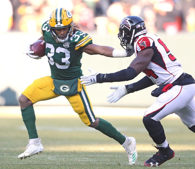 Green Bay Packers running back Aaron Jones (33) stiff arms a tackler on a run against the Atlanta Falcons Sunday, December 9, 2018 at Lambeau Field in Green Bay, Wis. Jim Matthews/USA TODAY NETWORK-Wis