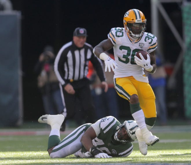 Green Bay Packers' Jamaal Williams eludes a tackle by New York Jets' Jordan Jenkins during first half of the Green Bay Packers game against the New York Jets at MetLife Stadium Sunday, Dec. 23, 2018, in East Rutherford.
