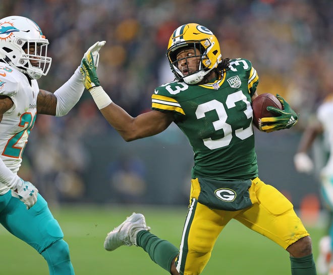 Green Bay Packers running back Aaron Jones (33) fends off a tackler against the Miami Dolphins at Lambeau Field Sunday, November 11, 2018 in Green Bay, Wis. Jim Matthews/USA TODAY NETWORK-Wis