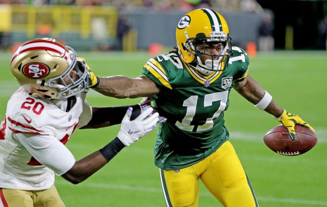 Green Bay Packers wide receiver Davante Adams (17) stiff arms cornerback Jimmie Ward (20) against the San Francisco 49ers at Lambeau Field Monday, October 15, 2018 in Green Bay, Wis.