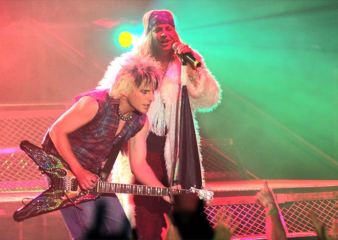 Lead singer Bret Michaels, right, takes to the stage with guitarist C.C. DeVille during Poison's sold-out performance at Oneida Bingo & Casino's Pavilion Nights in 2001.