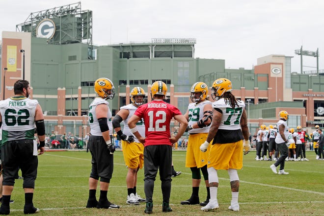 Green Bay Packers quarterback Aaron Rodgers (12) talks with his offensive linemen during practice at Clarke Hinkle Field on Wednesday, May 29, 2019 in Ashwaubenon, Wis.